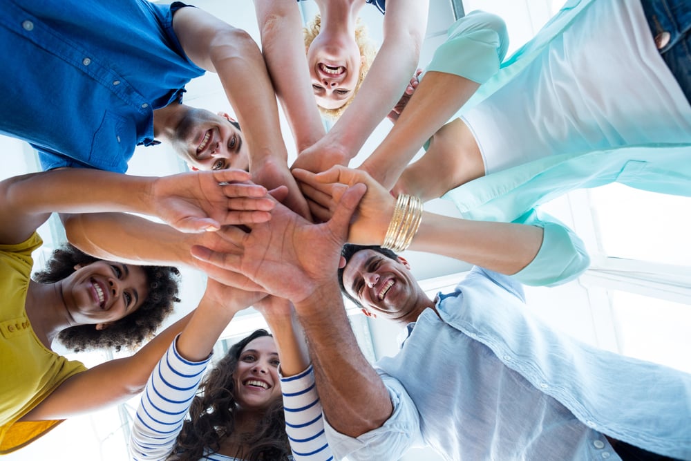 Creative team putting their hands together in circle Creative team putting their hands together in circle